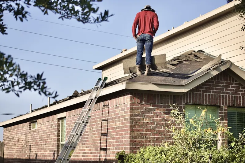 Professional roofer working on a residential roof in Russia